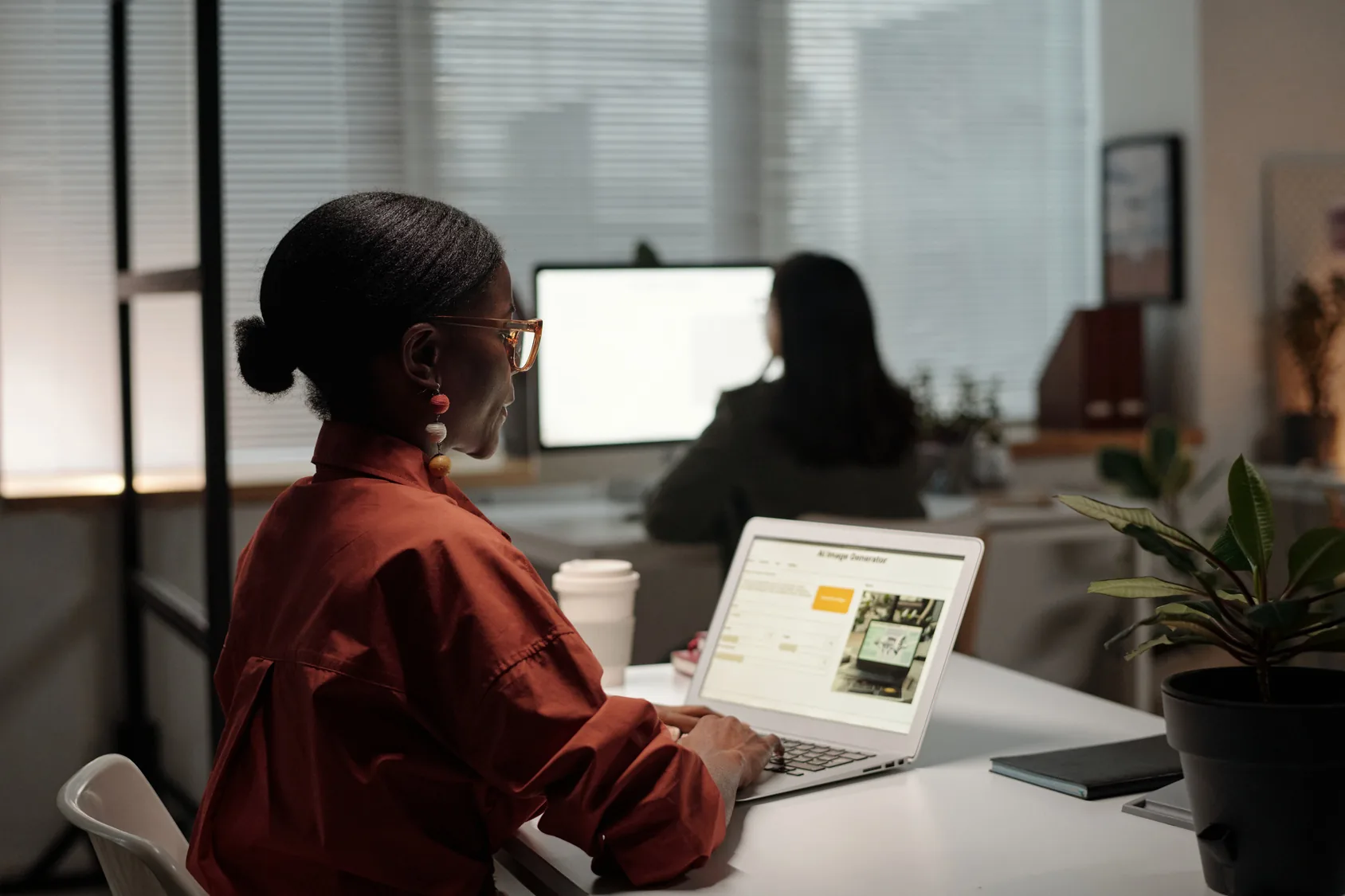 A professional reviewing an AI tool on a laptop in a modern office