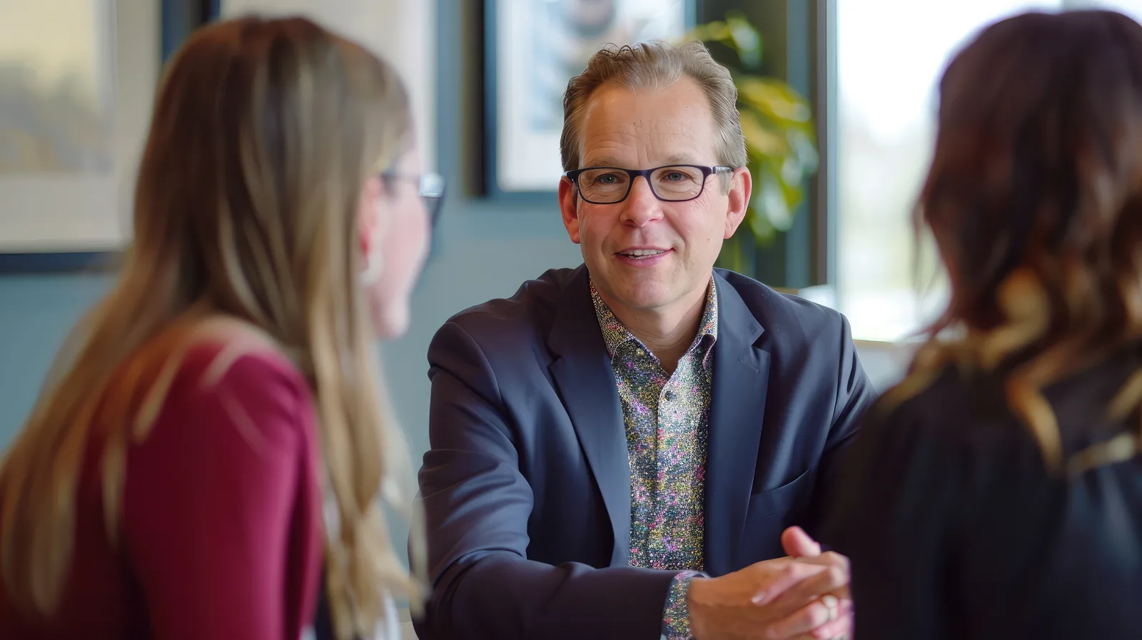An advisor reviewing a compliance plan with a client across a table