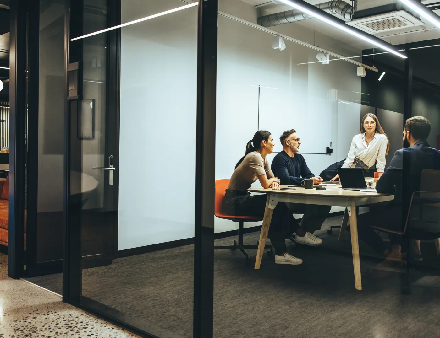 Law firm team meeting in a modern glass conference room