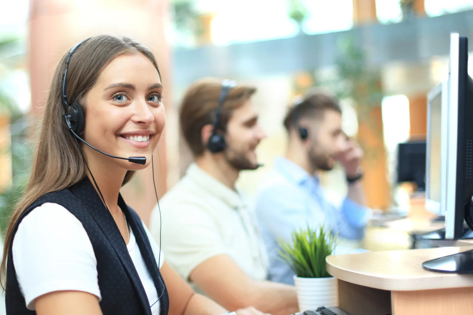 A contact center team taking calls with headsets