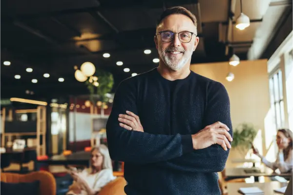 Mature businessman standing in a co-working space