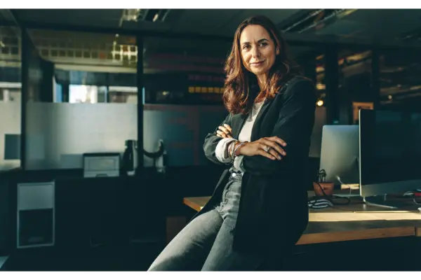 Mature businesswoman sitting on her desk