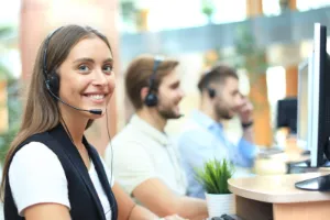 Attractive positive young businesspeople and colleagues in a call center office.