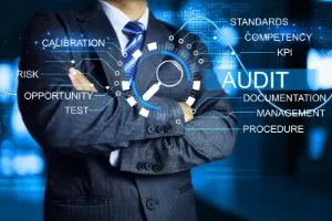 Auditor standing with cross arm to audit factory annual assessment every year to ensure activities are conform to correct in law and plan to meet quality standards KPI target ISO 9001